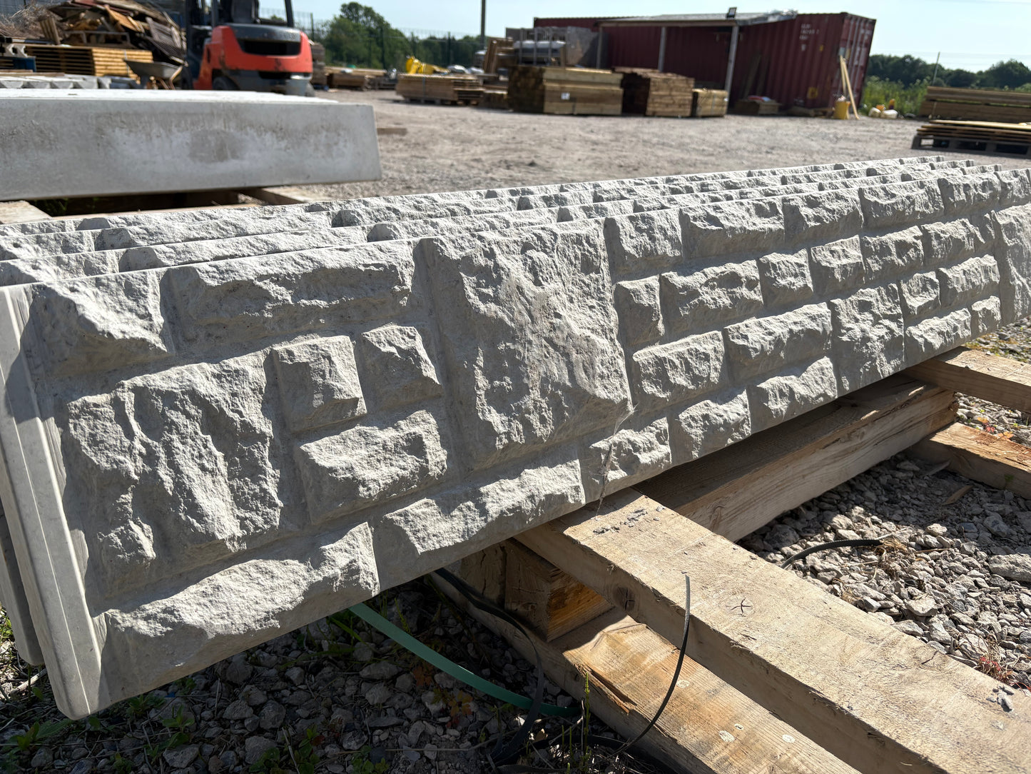Patterned concrete gravel boards for use in outdoor fencing projects.